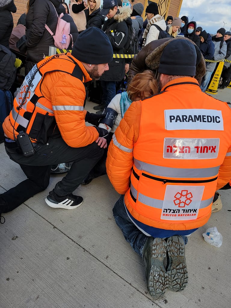 Treating a refugee who fainted while waiting in line at the border crossing.